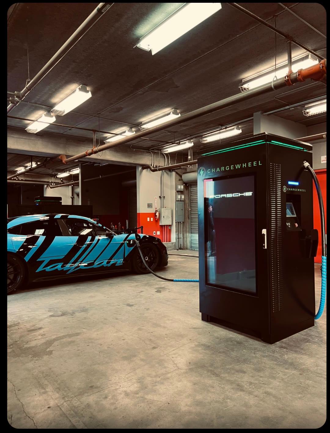 ChargeWheel DC fast charger in a fleet depot powering a Porsche Taycan